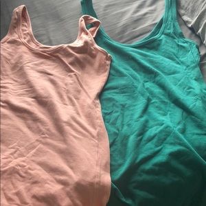 One small pink tank and one medium green tank